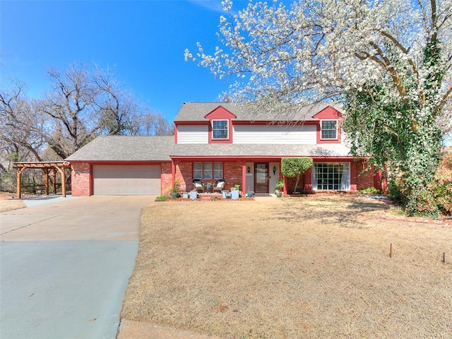 traditional home featuring a front yard, roof with shingles, an attached garage, concrete driveway, and brick siding