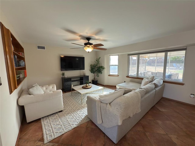 tiled living room with ceiling fan