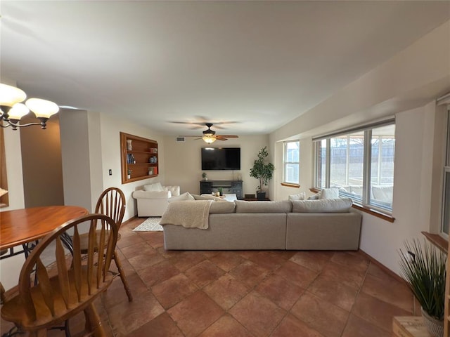 living room with ceiling fan with notable chandelier