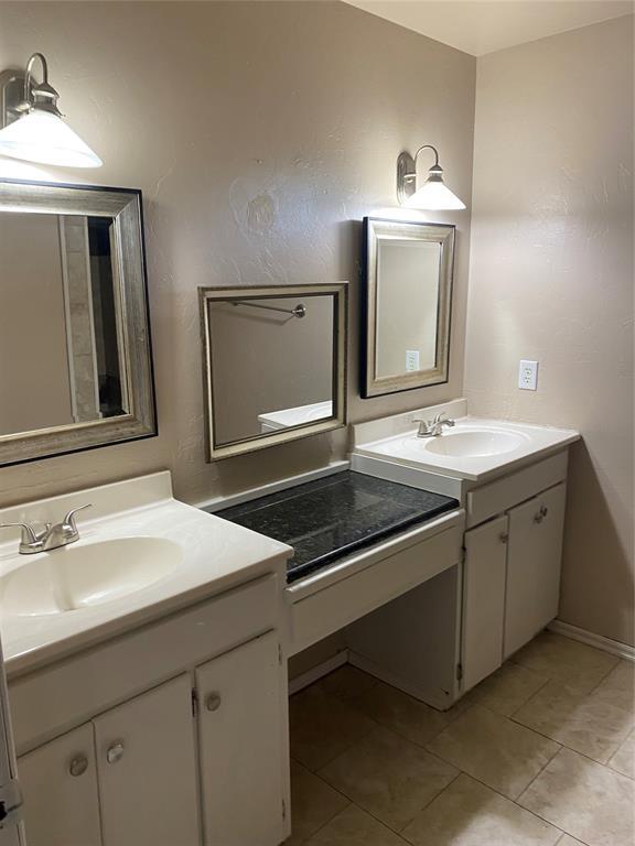 bathroom with tile patterned floors and vanity