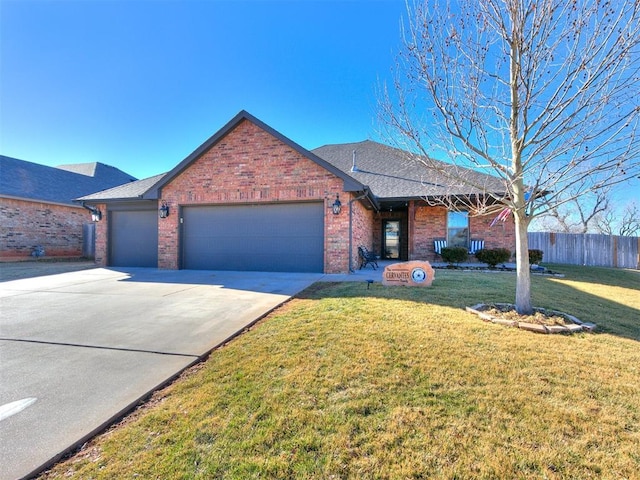 view of front of house featuring a garage and a front lawn