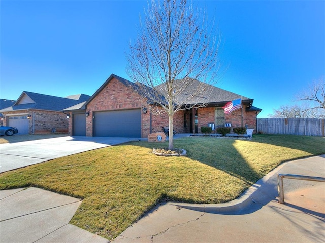 ranch-style house featuring a garage and a front lawn