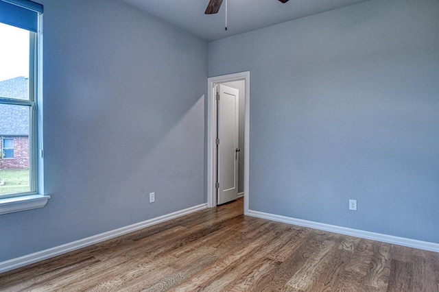 spare room featuring hardwood / wood-style flooring and ceiling fan