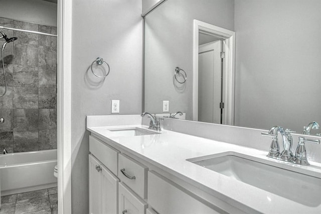 full bathroom featuring vanity, toilet, and tiled shower / bath combo