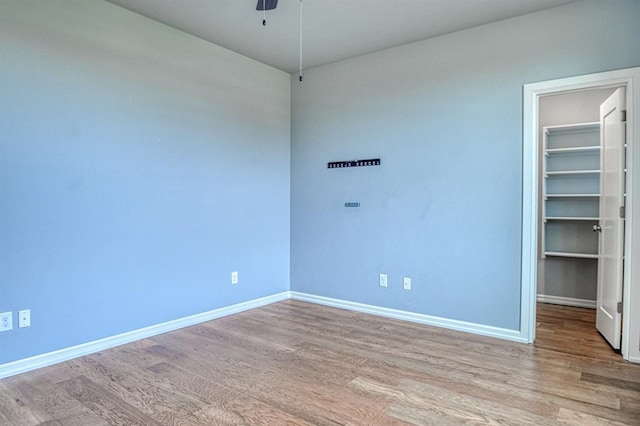 unfurnished room featuring ceiling fan and light wood-type flooring