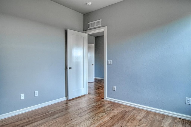 unfurnished room featuring hardwood / wood-style floors