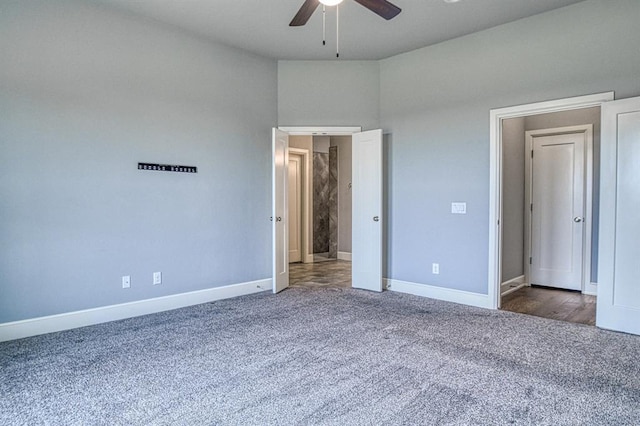 unfurnished bedroom featuring ceiling fan and dark colored carpet