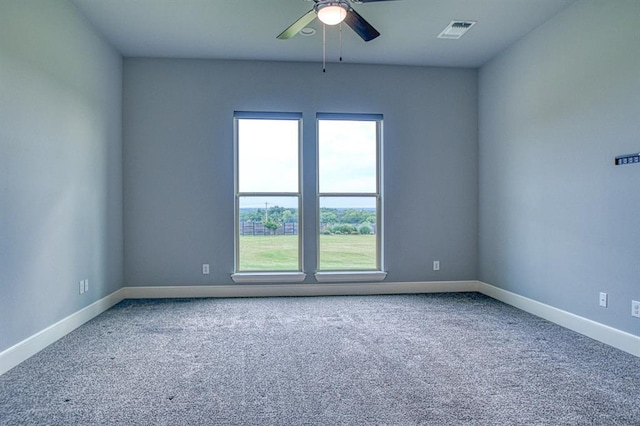 carpeted spare room with ceiling fan