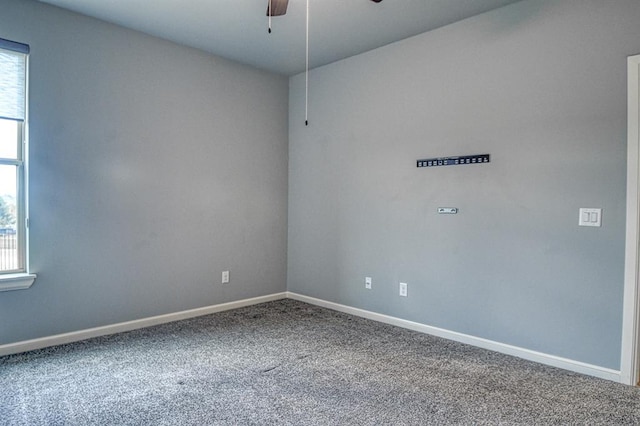 spare room featuring ceiling fan and carpet flooring