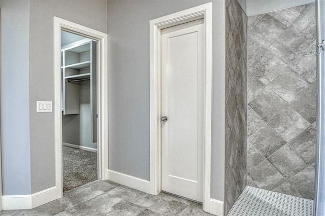 bathroom with tiled shower