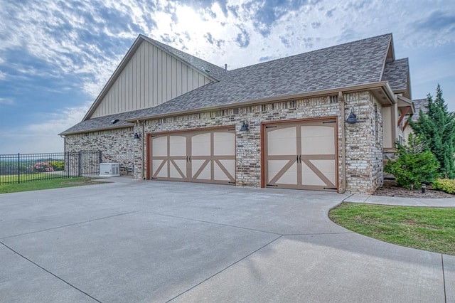 view of property exterior with a garage and central AC