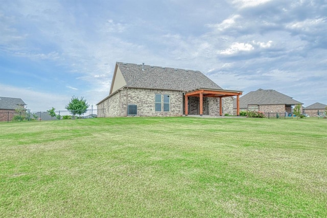 rear view of property featuring a lawn