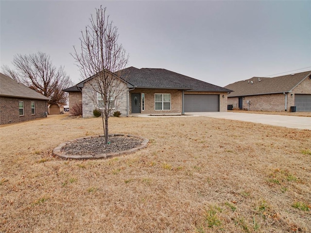 ranch-style home featuring a garage and a front lawn