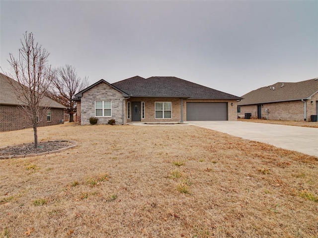 ranch-style home featuring a garage and a front yard