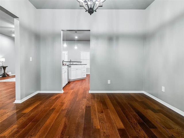 interior space with dark hardwood / wood-style floors and a chandelier