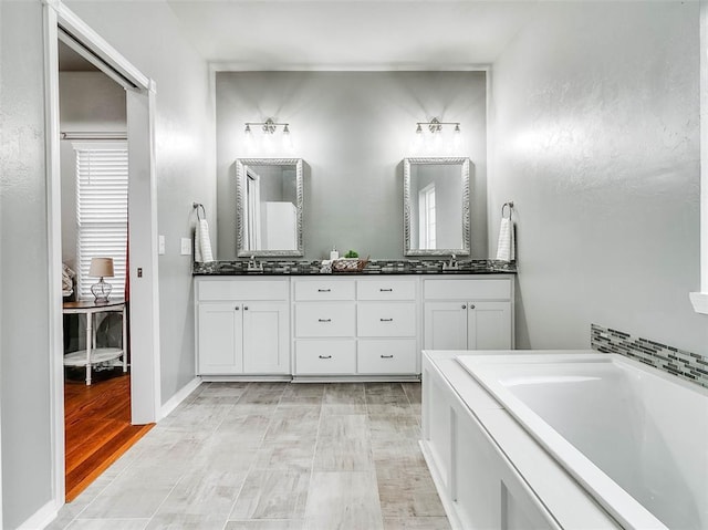 bathroom featuring vanity and a bathing tub