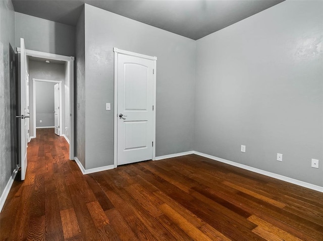 unfurnished room featuring dark hardwood / wood-style floors