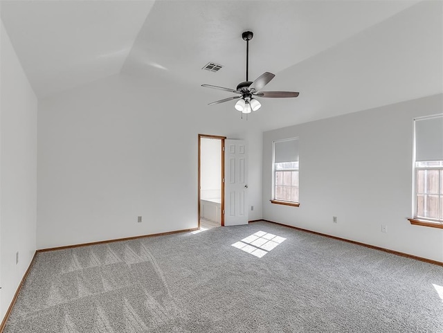 carpeted spare room with vaulted ceiling and ceiling fan