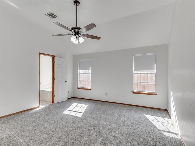 carpeted spare room with ceiling fan and lofted ceiling