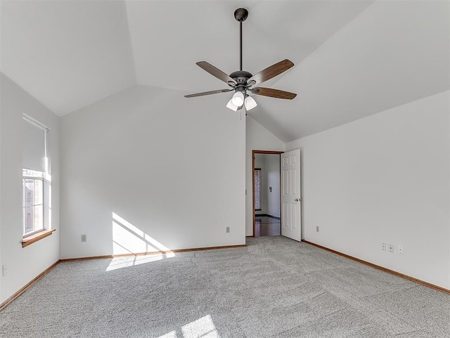 spare room with high vaulted ceiling, light colored carpet, and ceiling fan