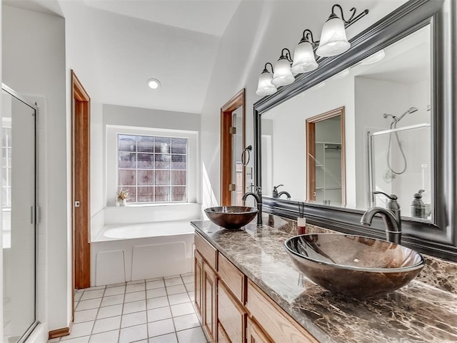 bathroom featuring tile patterned floors, plus walk in shower, and vanity