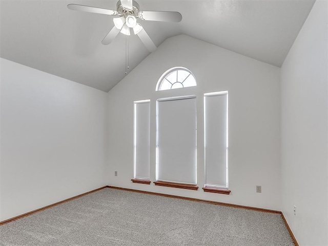 empty room featuring lofted ceiling, carpet floors, and ceiling fan