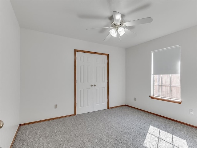 unfurnished bedroom with carpet, ceiling fan, and a closet