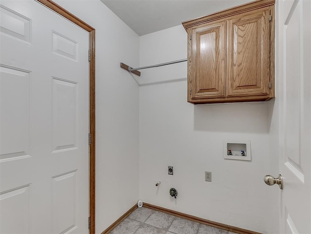 washroom with cabinets, gas dryer hookup, electric dryer hookup, and washer hookup