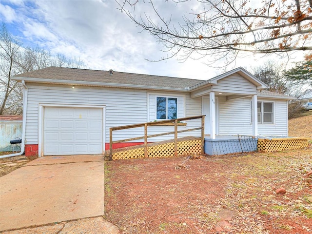 ranch-style house featuring a garage and covered porch