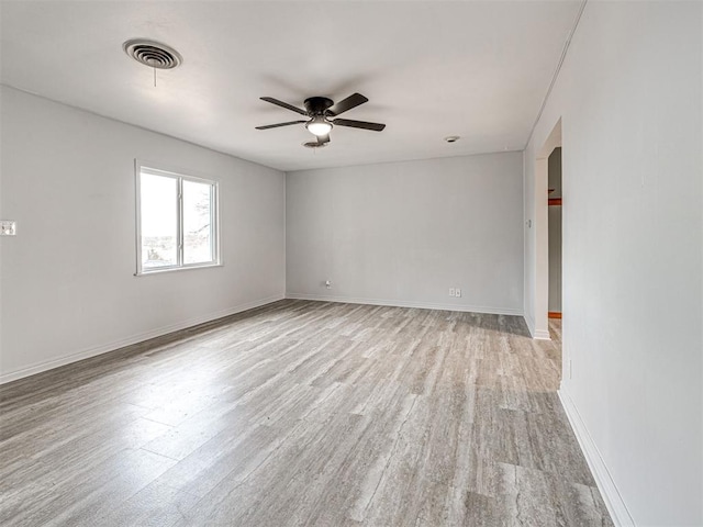 spare room featuring ceiling fan and light wood-type flooring