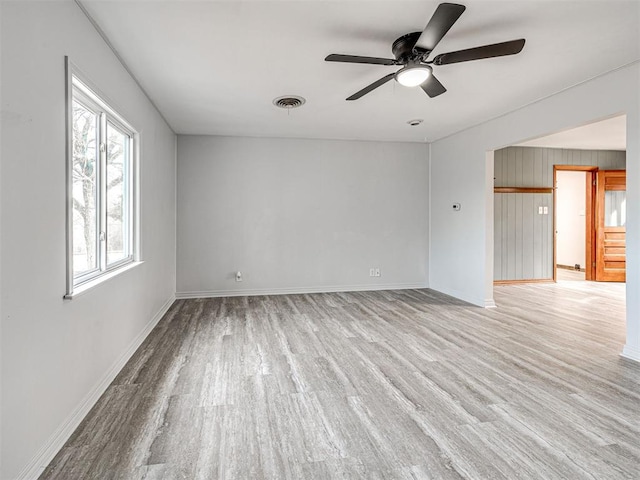 empty room featuring light hardwood / wood-style flooring and ceiling fan