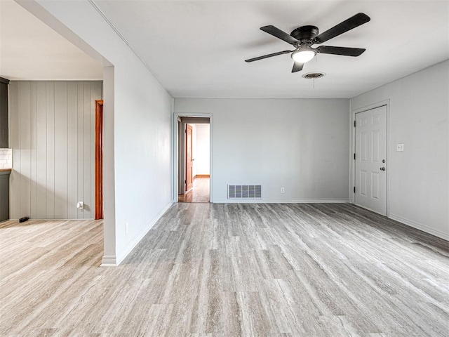 unfurnished living room featuring ceiling fan and light wood-type flooring