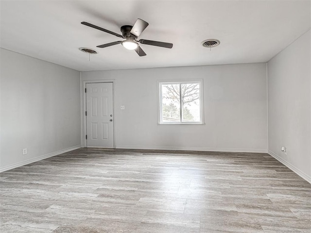 unfurnished room with ceiling fan and light wood-type flooring