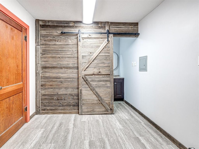 interior space featuring a barn door and light hardwood / wood-style floors