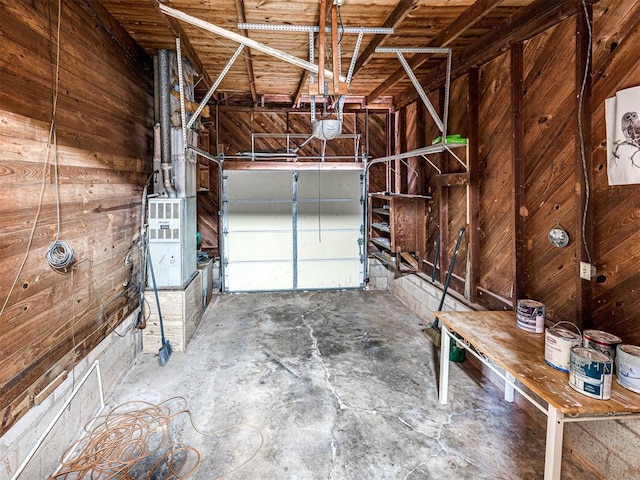 garage with a garage door opener and wooden walls