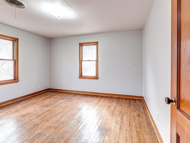 spare room with light hardwood / wood-style flooring