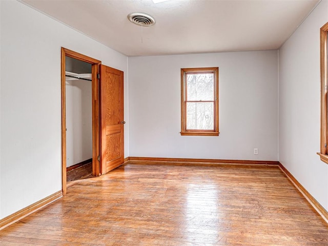 unfurnished bedroom with light wood-type flooring