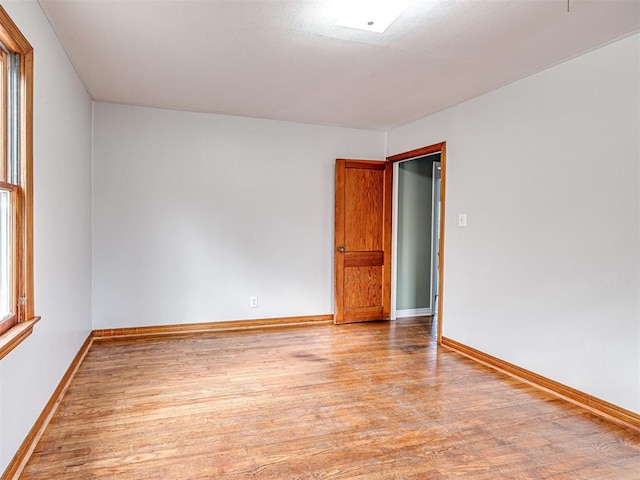 unfurnished room with light wood-type flooring