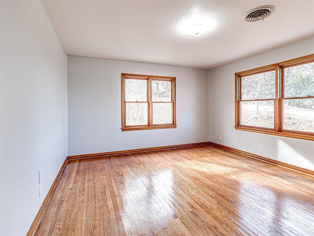 unfurnished room featuring light hardwood / wood-style flooring and a healthy amount of sunlight