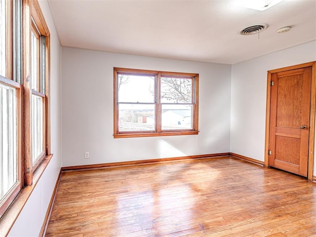 unfurnished room with light hardwood / wood-style flooring