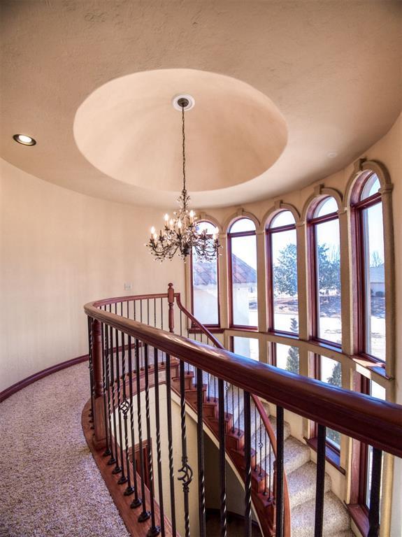 7 Country Club Rd, Shawnee, OK 74801 - hall with a raised ceiling, carpet flooring, and a notable chandelier