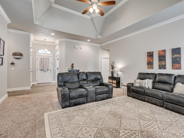 carpeted living room with crown molding, ceiling fan with notable chandelier, and a towering ceiling