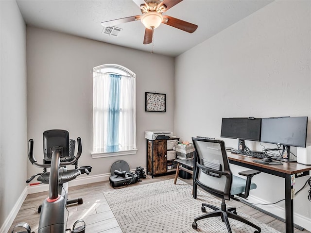 office space featuring ceiling fan and light hardwood / wood-style floors