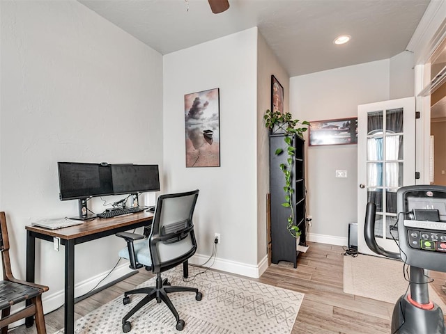 office with ceiling fan and light hardwood / wood-style floors