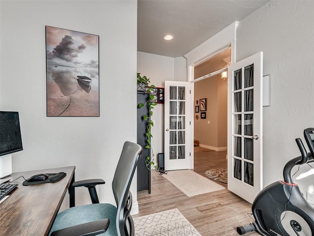 home office featuring french doors and light hardwood / wood-style flooring