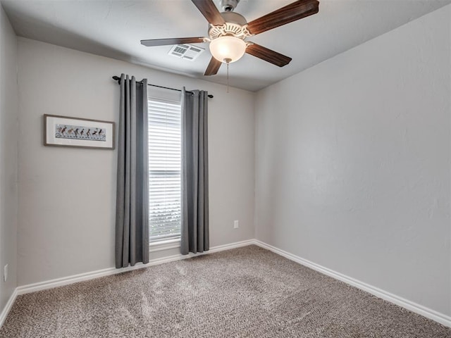 carpeted spare room with ceiling fan