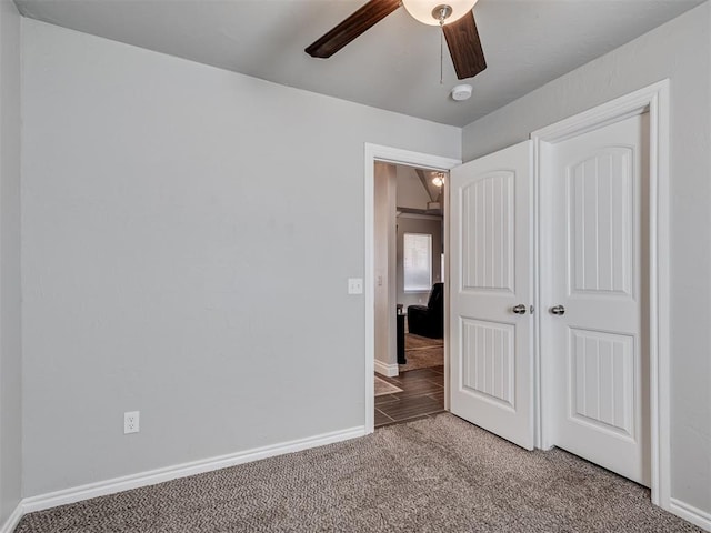 unfurnished bedroom with ceiling fan and carpet floors