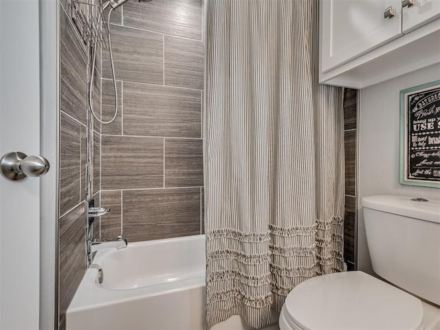 bathroom featuring shower / bath combo and toilet