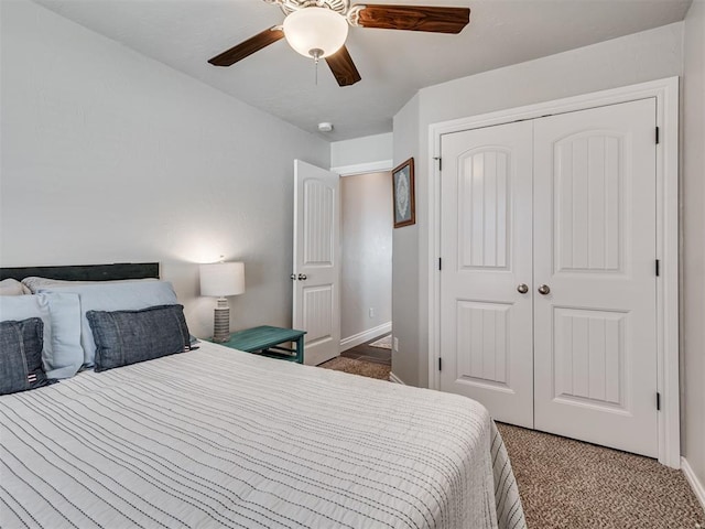 carpeted bedroom with ceiling fan and a closet