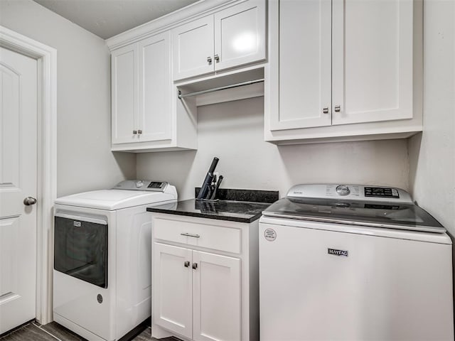 washroom with cabinets and washing machine and dryer